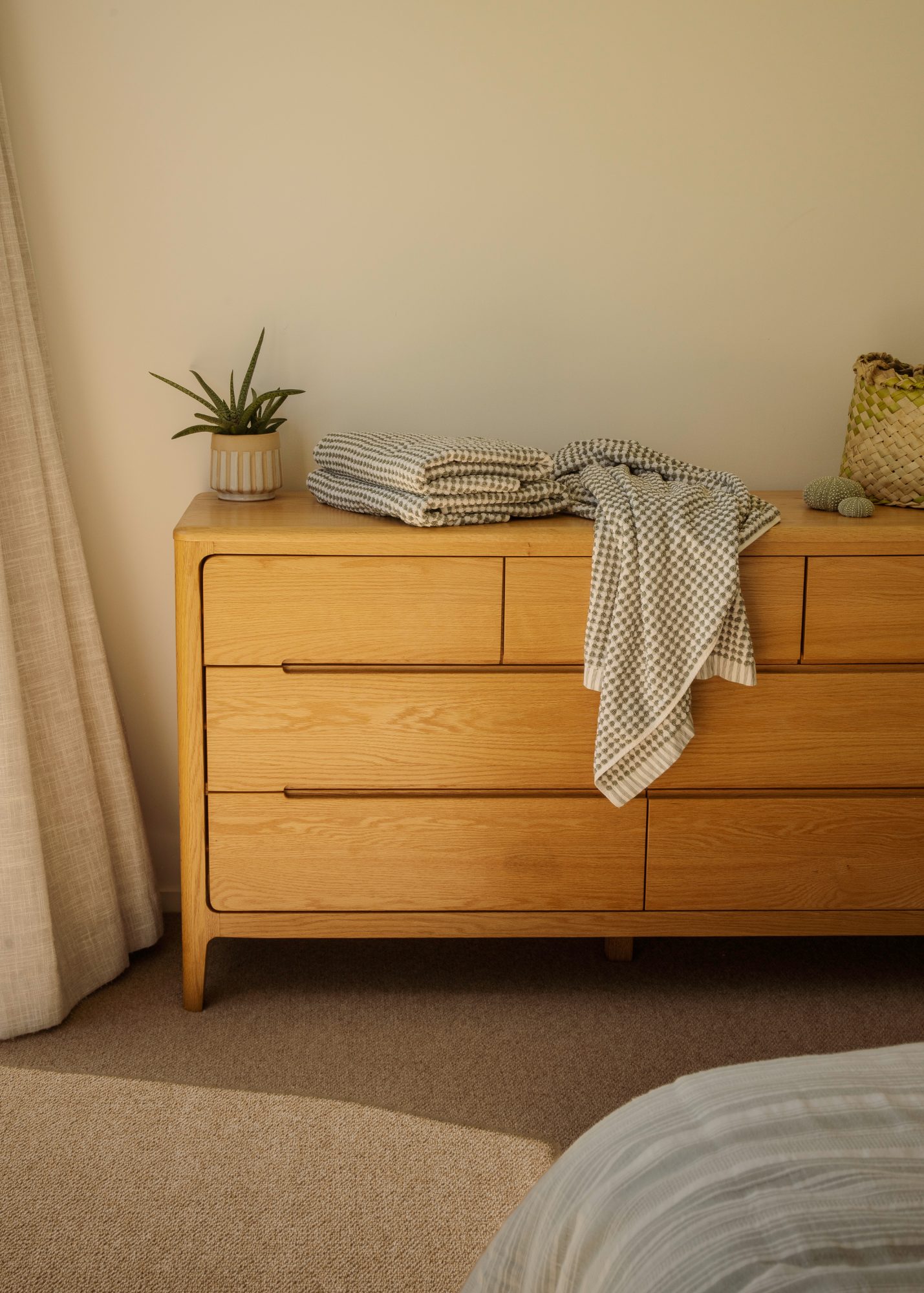 Awa Coastal oak dresser with towels and woven kete, Whangapoua interior photography NZ