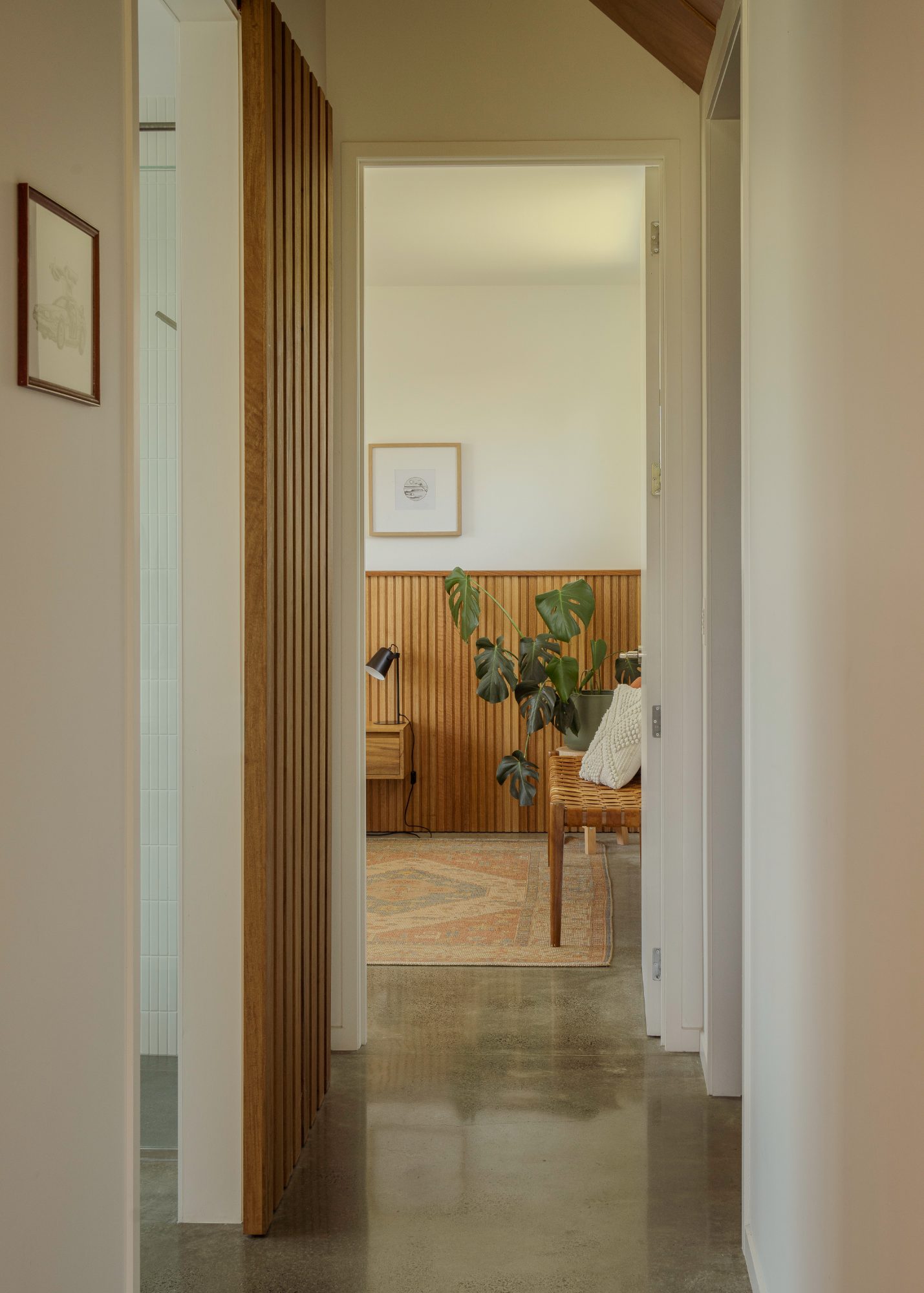 Awa Coastal hallway view into bedroom with timber panelling, Whangapoua interior photography NZ