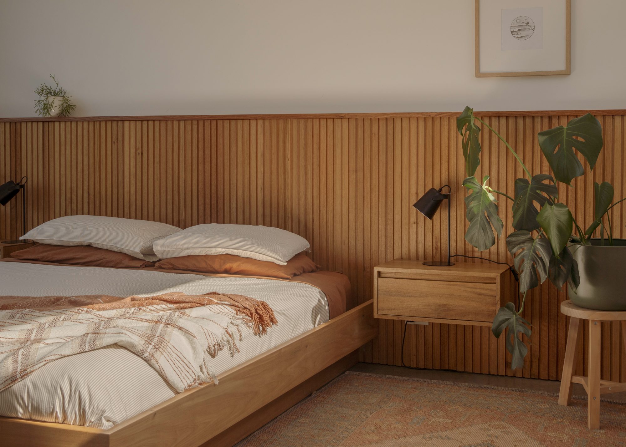 Awa Coastal main bedroom with timber battened headboard wall, Whangapoua interior photography NZ