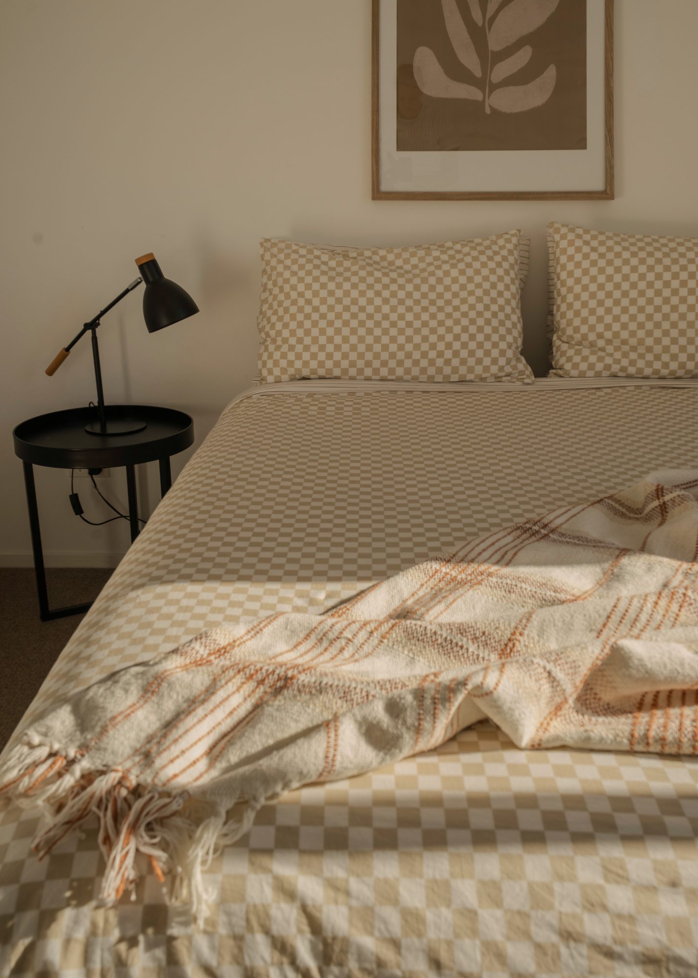 Awa Coastal guest bedroom with checked bedding and throw, Whangapoua interior photography NZ