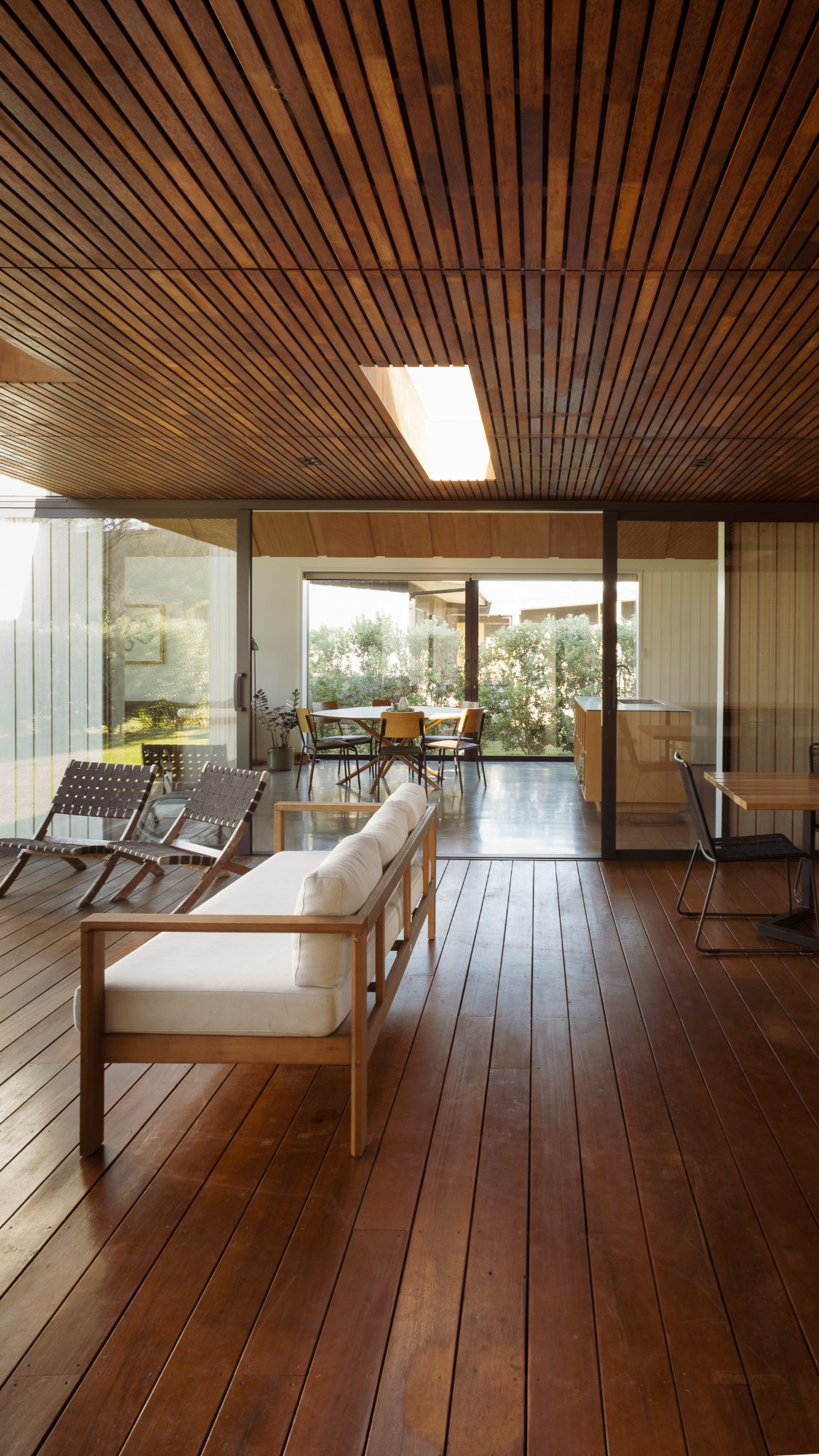 Awa Coastal covered deck looking through to the dining area, Whangapoua interior photography NZ