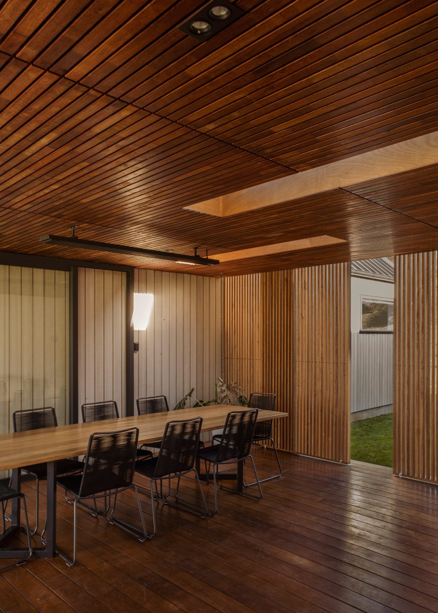 Awa Coastal outdoor dining room under slatted timber ceiling,  New Zealand architectural photography
