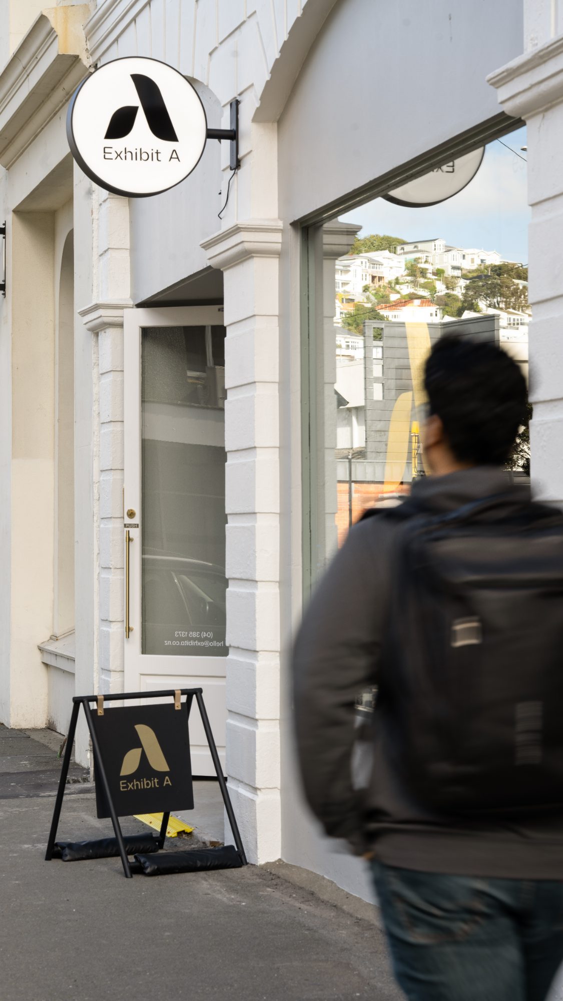 Exhibit A storefront with street life, Wellington commercial photography NZ