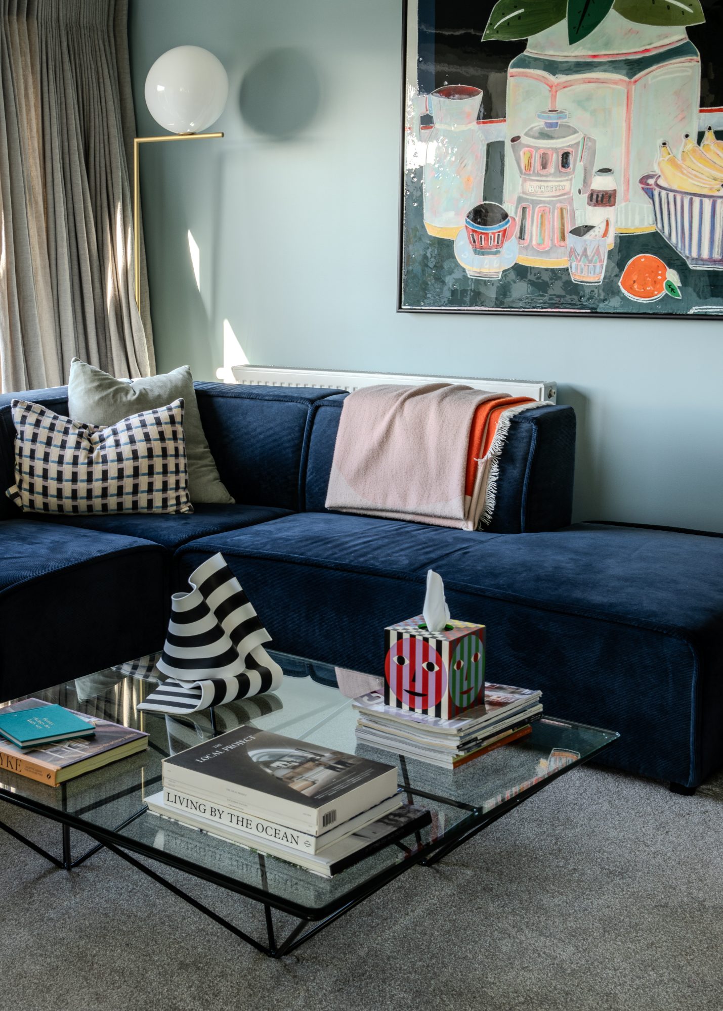 Seatoun House navy velvet sofa with still life artwork, Wellington interior photography NZ