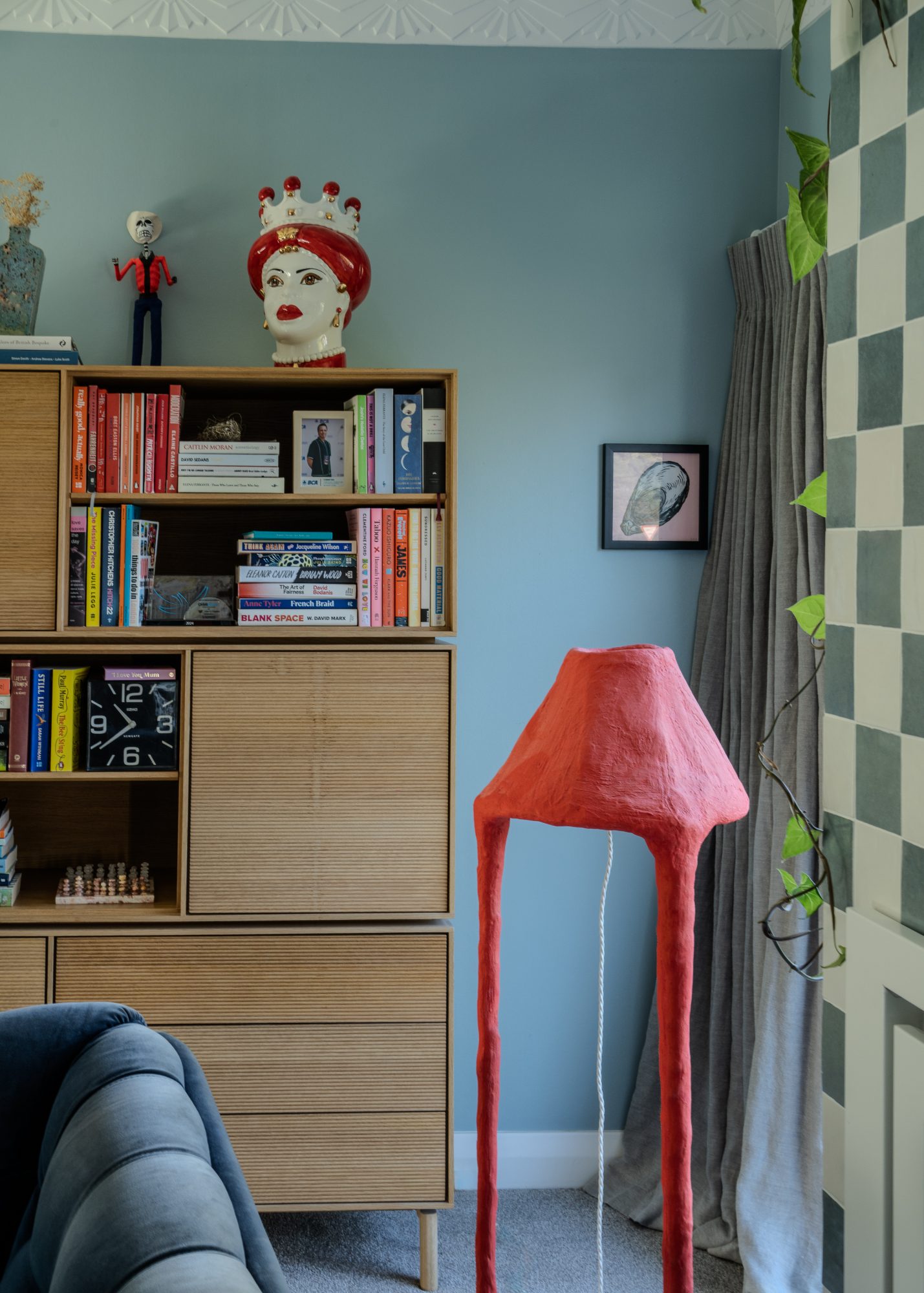 Seatoun House bookshelf with red sculptural floor lamp, Wellington interior photography NZ